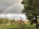 View of a house with a rainbow in the background, showcasing scenic surroundings at 12041 Twilight St, Longmont, CO 80503