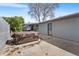 The backyard features a partially covered patio, hot tub, and a gray brick home exterior at 415 Lamar St, Lakewood, CO 80226