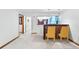 Cozy basement with stone-accented bar, chairs, and view into another room at 415 Lamar St, Lakewood, CO 80226