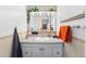 Bathroom with white vanity, large mirror with overhead lighting, and neutral-toned tiling at 415 Lamar St, Lakewood, CO 80226