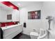 Modern bathroom featuring sleek vanity, tiled wall, contemporary art, and updated fixtures at 415 Lamar St, Lakewood, CO 80226