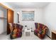 Bedroom featuring two colorful chairs and closet space at 415 Lamar St, Lakewood, CO 80226