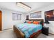 Bright bedroom featuring a bed with blue covers, wooden blinds, and unique decor at 415 Lamar St, Lakewood, CO 80226