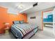 Finished basement bedroom with egress window view to the recreation space at 415 Lamar St, Lakewood, CO 80226