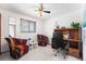 Bedroom featuring two colorful chairs, desk, and ceiling fan at 415 Lamar St, Lakewood, CO 80226