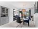 Well-lit dining room featuring a glass table and view to the kitchen at 415 Lamar St, Lakewood, CO 80226