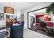 Bright dining room with a glass table, pendant lighting, and an open view to the kitchen at 415 Lamar St, Lakewood, CO 80226