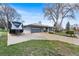 A lovely house with a driveway, trees, and well-maintained exterior creates an inviting curb appeal at 415 Lamar St, Lakewood, CO 80226