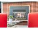 Close-up of the fireplace highlighting the detailed brick surround and inviting hearth at 415 Lamar St, Lakewood, CO 80226