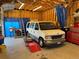 Spacious garage interior with a van, ladder, and tool storage at 415 Lamar St, Lakewood, CO 80226