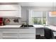 Kitchen features streamlined counter and storage space with a sink near a sliding window and eat-in seating at 415 Lamar St, Lakewood, CO 80226