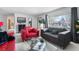 Bright living room featuring a cozy seating area, a large window, and neutral-toned carpet at 415 Lamar St, Lakewood, CO 80226