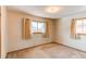 Simple bedroom with neutral walls, carpet, and good natural light from two windows at 1976 S Quitman St, Denver, CO 80219