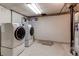 Functional laundry area featuring modern washer and dryer units, designed for efficiency and ease of use at 1976 S Quitman St, Denver, CO 80219