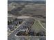 Aerial view of a suburban neighborhood with houses lining the street, offering a view of the surrounding open landscape at 5503 Fullerton Cir, Highlands Ranch, CO 80130