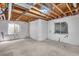 Unfinished basement with exposed beams and large windows at 5503 Fullerton Cir, Highlands Ranch, CO 80130