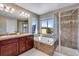 This bathroom offers double sinks, a soaking tub, and a glass enclosed shower at 5503 Fullerton Cir, Highlands Ranch, CO 80130
