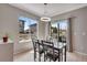 This dining room is filled with natural light and features a modern chandelier and views of the backyard at 5503 Fullerton Cir, Highlands Ranch, CO 80130