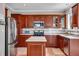 This spacious kitchen is complete with stainless steel appliances, custom cabinets, quartz countertops, and subway tile backsplash at 5503 Fullerton Cir, Highlands Ranch, CO 80130