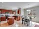 Eat-in kitchen has stainless appliances, wood cabinets, quartz countertops, subway tile backsplash and eat-in nook with table at 5503 Fullerton Cir, Highlands Ranch, CO 80130