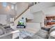 Bright living room features a soaring ceiling, hardwood floors, and a staircase leading to the second floor at 5503 Fullerton Cir, Highlands Ranch, CO 80130