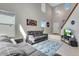 Bright living room with vaulted ceilings, neutral walls, and comfortable gray sofas on an area rug at 5503 Fullerton Cir, Highlands Ranch, CO 80130