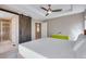 A bright main bedroom features a barn door and a sleek ceiling fan at 5503 Fullerton Cir, Highlands Ranch, CO 80130