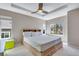 Relax in this spacious main bedroom featuring a tray ceiling, ceiling fan, and natural light at 5503 Fullerton Cir, Highlands Ranch, CO 80130