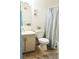 Bathroom featuring wood-look flooring, cabinet, toilet, and shower-tub combo at 14413 E Jewell Ave # 201, Aurora, CO 80012