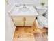 Bathroom featuring a white sink with cabinet, modern fixtures, and wood grain floors at 14413 E Jewell Ave # 201, Aurora, CO 80012