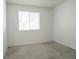 Bedroom with a large window allowing for natural light and neutral colored carpet at 14413 E Jewell Ave # 201, Aurora, CO 80012