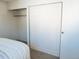 Bedroom features a closet with folding doors and neutral-colored carpet at 14413 E Jewell Ave # 201, Aurora, CO 80012
