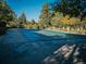 Community pool covered for the off-season with mature trees surrounding the area at 14413 E Jewell Ave # 201, Aurora, CO 80012