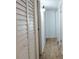 Hallway with wood-look flooring, white doors, and overhead lighting at 14413 E Jewell Ave # 201, Aurora, CO 80012