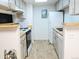 Compact kitchen with stainless steel appliances and functional layout at 14413 E Jewell Ave # 201, Aurora, CO 80012