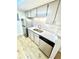 Modern kitchen featuring stainless appliances, white cabinets and light-colored floor at 14413 E Jewell Ave # 201, Aurora, CO 80012