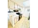 Bright kitchen features stainless appliances, white cabinets, and breakfast bar at 14413 E Jewell Ave # 201, Aurora, CO 80012