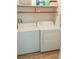 Convenient laundry room with a white washer and dryer, plus shelving for easy access to supplies at 14413 E Jewell Ave # 201, Aurora, CO 80012