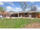 Spacious backyard featuring stone patio, outdoor seating, mature trees, and lush lawn at 269 Beryl Way, Broomfield, CO 80020