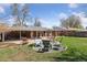 Landscaped backyard featuring patio, seating area, mature trees, and well maintained lawn at 269 Beryl Way, Broomfield, CO 80020