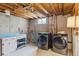 Unfinished basement with concrete walls and modern washer and dryer and laundry area at 269 Beryl Way, Broomfield, CO 80020