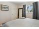 Cozy bedroom featuring a neutral color palette, light-colored wood floors, and ample natural light from the window at 269 Beryl Way, Broomfield, CO 80020