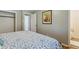 Bedroom featuring wood floors, a queen size bed, and a view into an en-suite bathroom at 269 Beryl Way, Broomfield, CO 80020