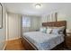 Bedroom with wood floors, a large bed, and ample natural light from the windows at 269 Beryl Way, Broomfield, CO 80020