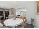 Bright dining area featuring a white round table and views into the living room and updated kitchen at 269 Beryl Way, Broomfield, CO 80020
