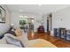 Open-concept living room with hardwood floors, comfortable seating, and a view to kitchen at 269 Beryl Way, Broomfield, CO 80020