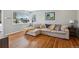Bright living room with hardwood floors, stylish sectional, and large windows at 269 Beryl Way, Broomfield, CO 80020