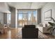 Stylishly staged living room showcasing hardwood floors and expansive city views at 891 14Th St # 2904, Denver, CO 80202