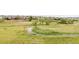 Community view showcasing open green space with pathway and residential buildings at 8944 Fox Dr # 203, Thornton, CO 80260