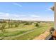 Community view showcasing open green space with pathway and residential buildings at 8944 Fox Dr # 203, Thornton, CO 80260